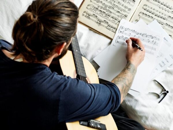 Man playing a guirtar composing